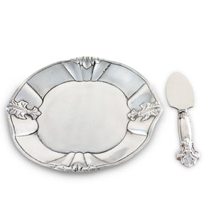 An elegant cheese set featuring a decorative plate with leaf accents and matching server, viewed from above, perfect for entertaining essentials.