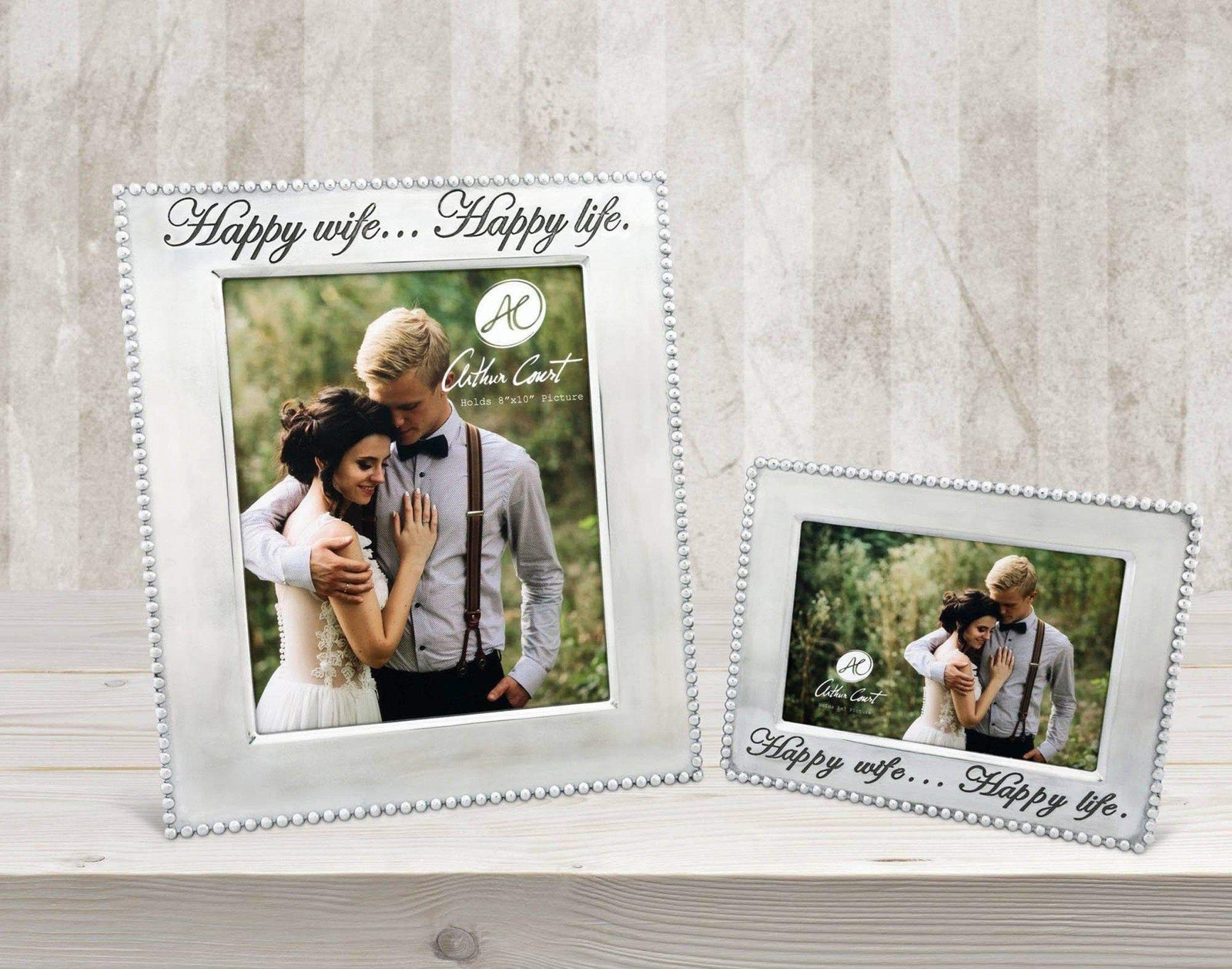 Two elegant photo frames adorned with delicate bead detailing and "Happy wife... Happy life" inscriptions, viewed at an angle on a wooden surface.