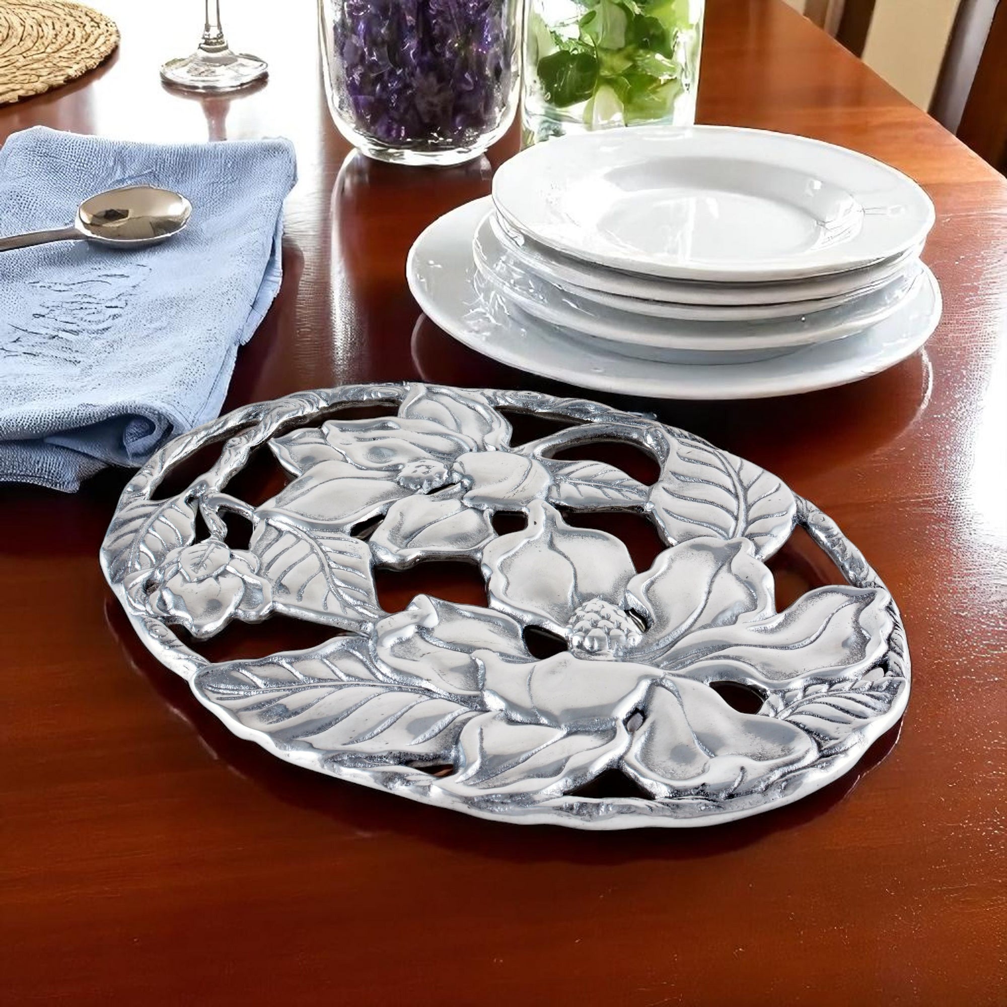 Intricately designed floral trivet in a perspective view, showcasing artisanal craftsmanship for elegant kitchen decor.