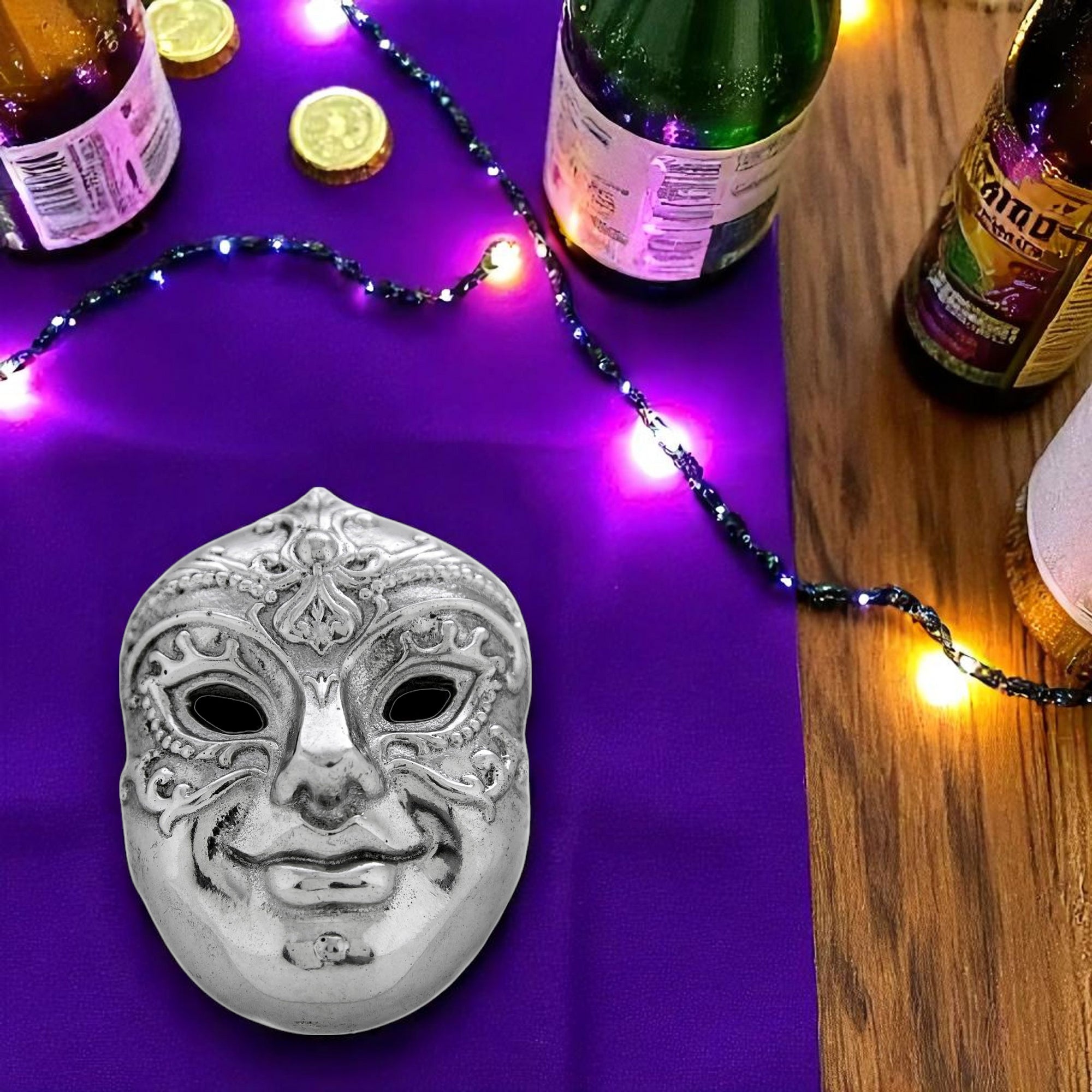 Intricately designed mask-shaped bottle opener in a front-facing angle, showcasing artisanal craftsmanship and premium material.