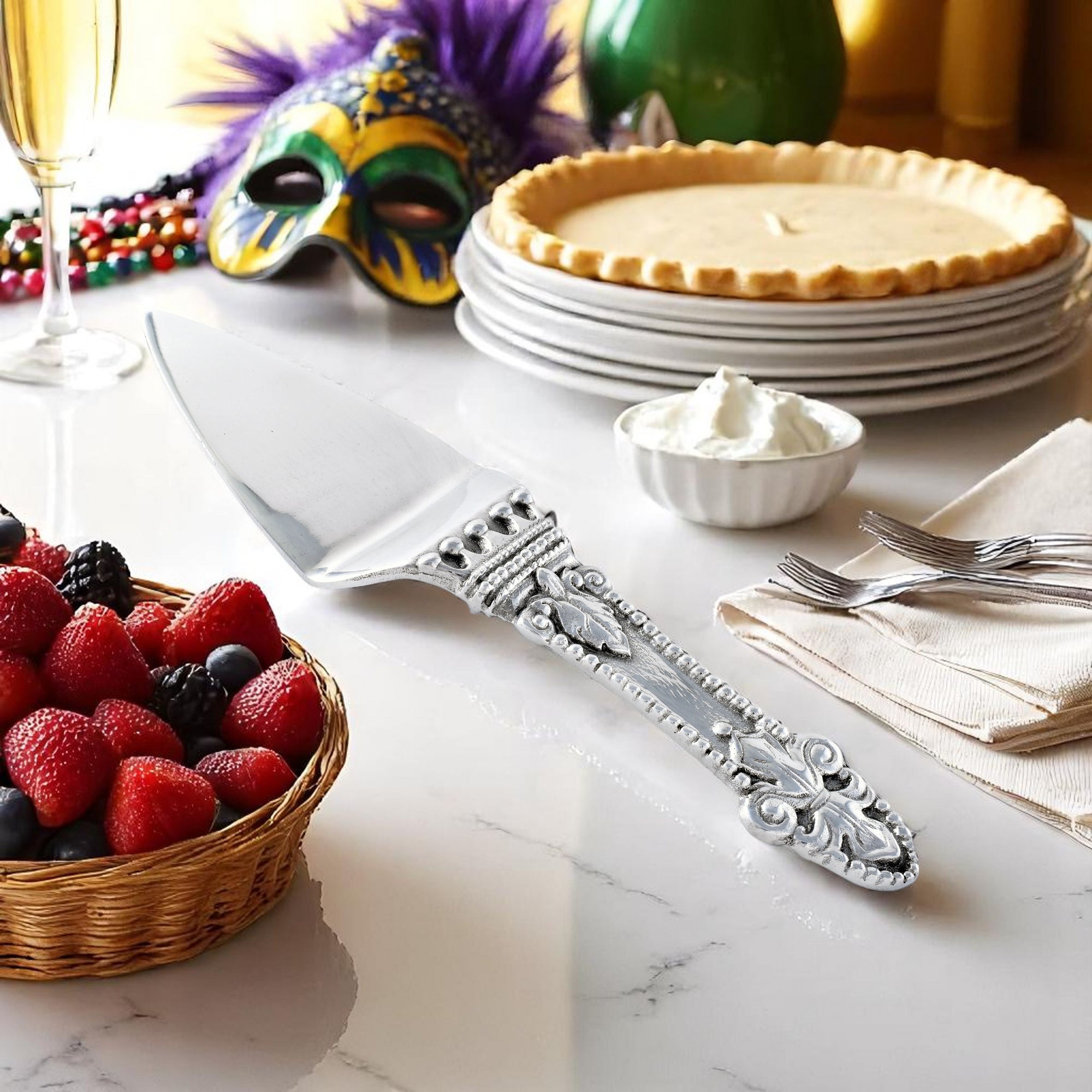 This pie server, viewed from a slight angle, showcases intricate handcrafted details on its handle, ideal for elegant table settings.