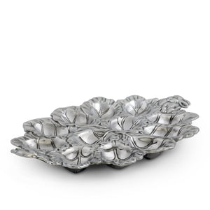 Silver deviled egg holder in a leaf motif, viewed from a side angle, showcases artisanal craftsmanship and elegant accent