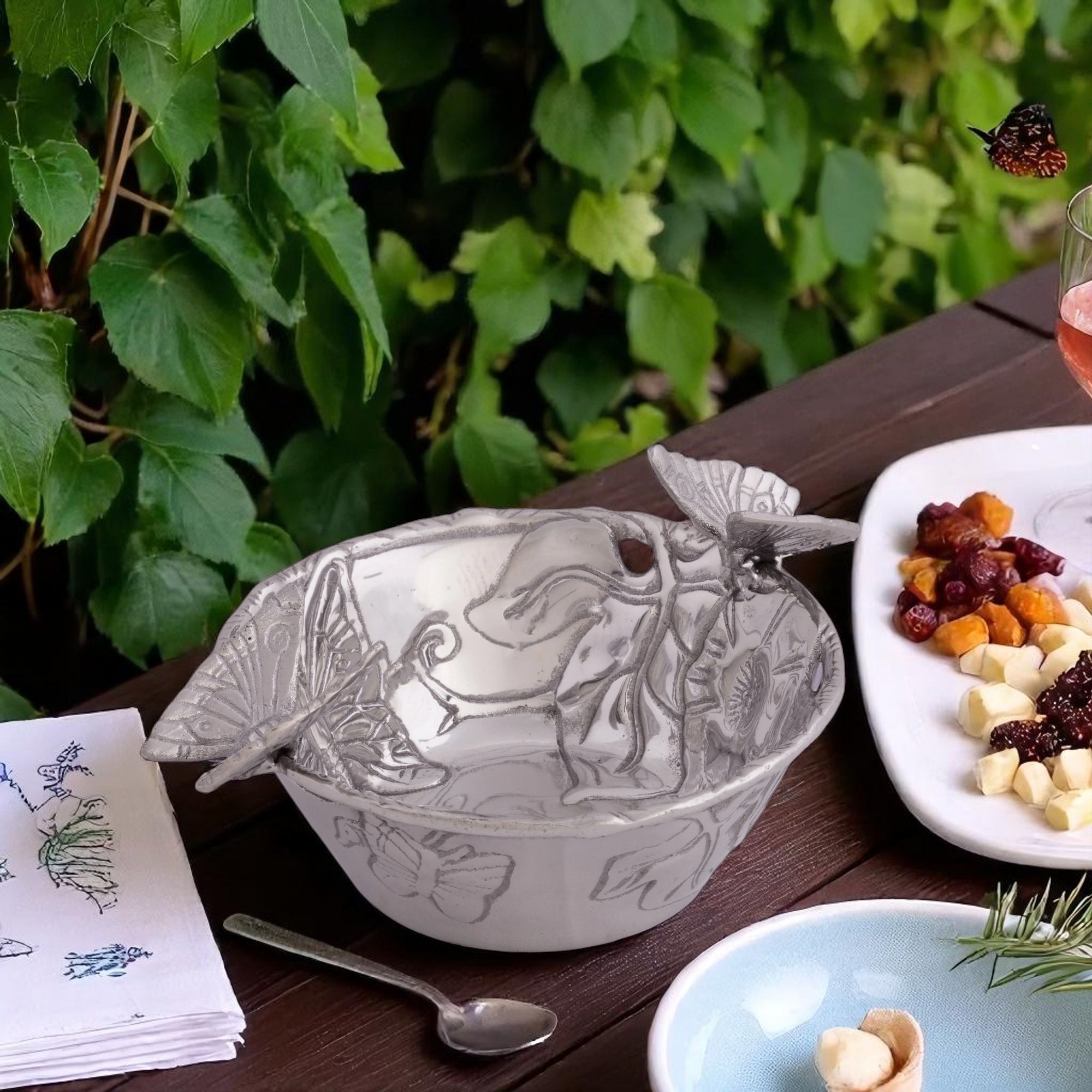 A beautifully crafted decorative nut bowl with butterfly embellishments, viewed from a slightly elevated angle, perfect for luxury home decor.