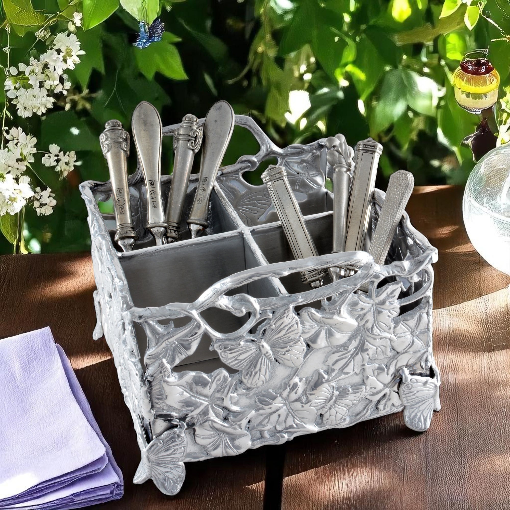 An intricately designed flatware caddy with butterfly motifs, viewed from an angled perspective, showcasing artisanal craftsmanship and elegant accents.