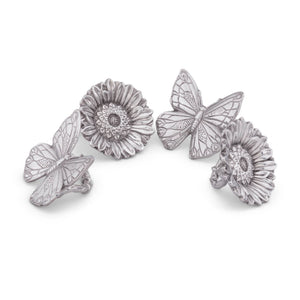 Butterfly and sunflower napkin rings elegantly displayed, viewed from above, showcasing artisanal craftsmanship and luxury home accessory appeal.