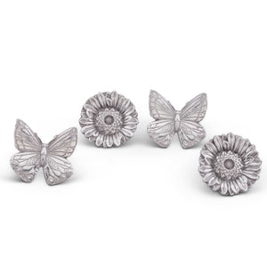 Elegant napkin rings featuring butterfly and flower designs, captured from above, ideal for designer tableware and table settings.