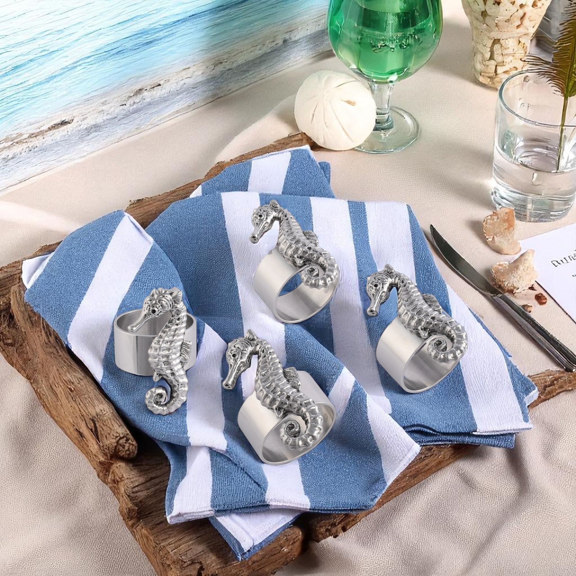 Four seahorse napkin rings are displayed in a close-up view, showcasing artisanal craftsmanship perfect for coastal decor.