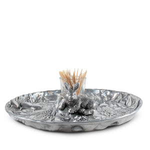 Elegant serving piece displays a rabbit figure and toothpicks in a textured decorative bowl, viewed from a side angle.