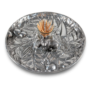In a close-up shot, a decorative plate features intricate leaf and rabbit details, making it a unique catch-all piece.