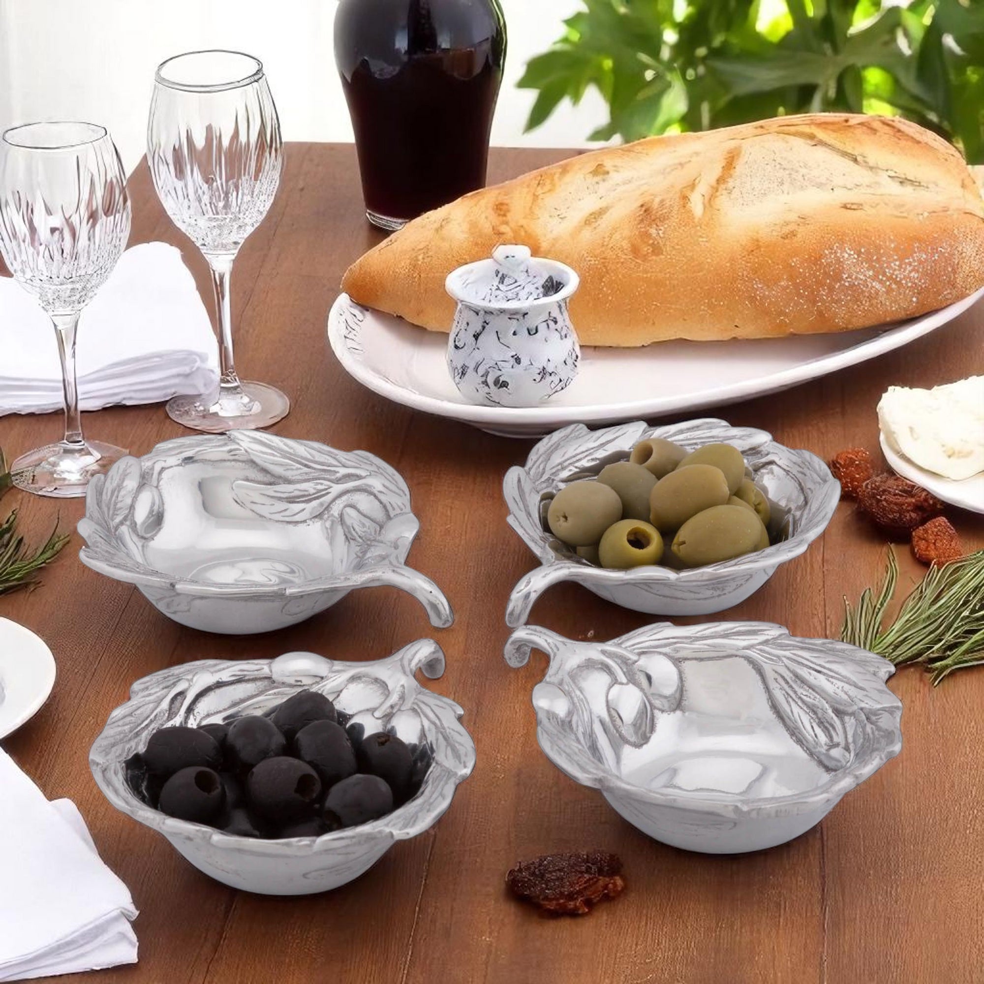 In a perspective view, decorative dip sauce bowls with olive motifs, crafted with artisanal detail, perfect for entertaining essentials.