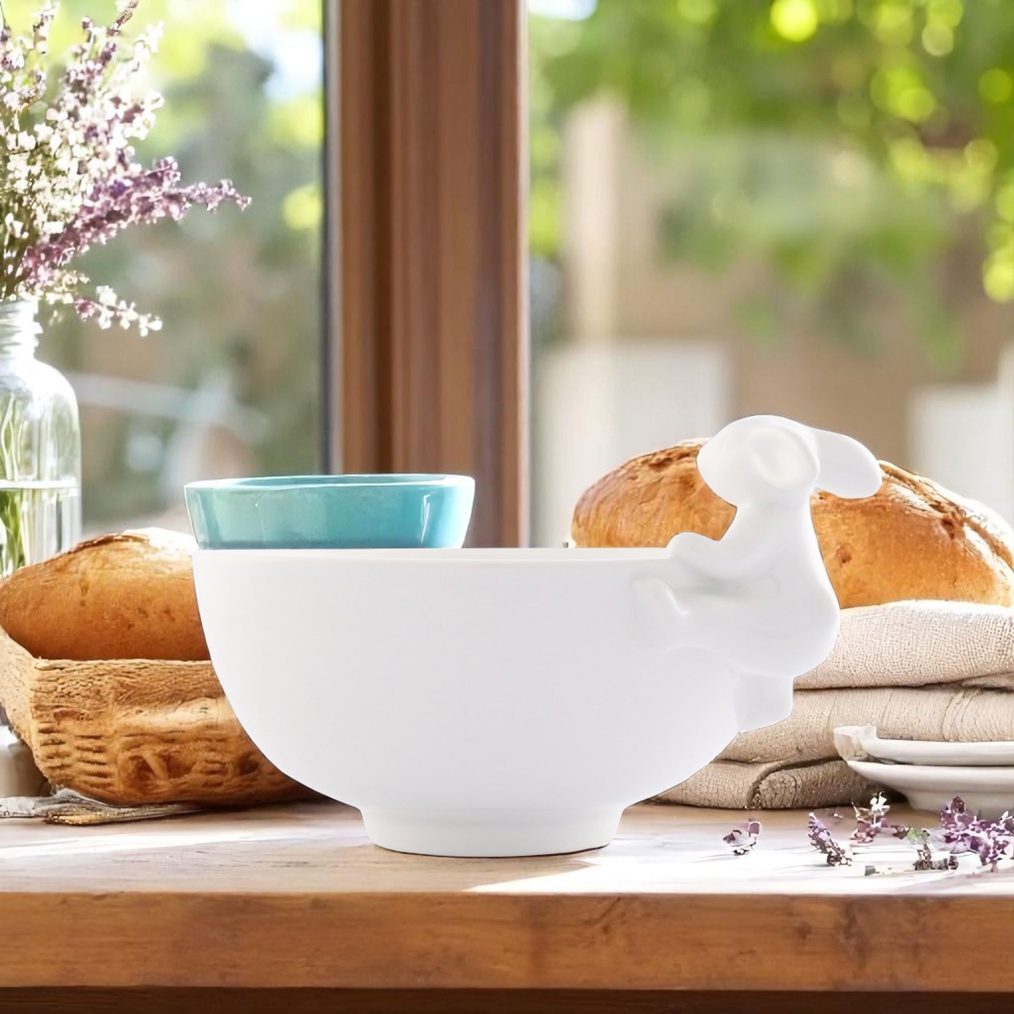 In a side view, a decorative serving bowl features an adorable bunny figure, ideal for kitchen decor.