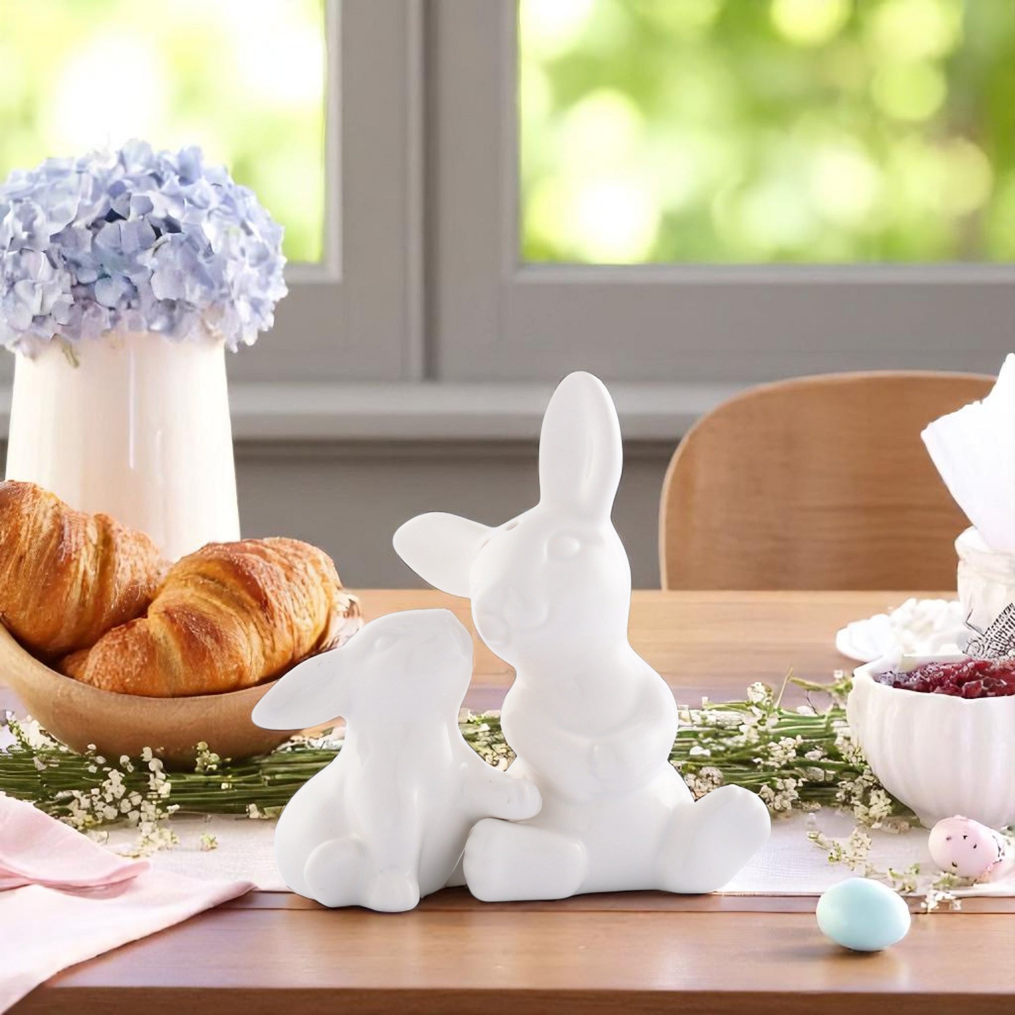 Playful rabbit salt and pepper set viewed from the side, showcasing artisanal craftsmanship in elegant white ceramic.