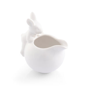 A whimsical creamer with a rabbit detail viewed from a slight angle, showcasing elegant artisanal craftsmanship.