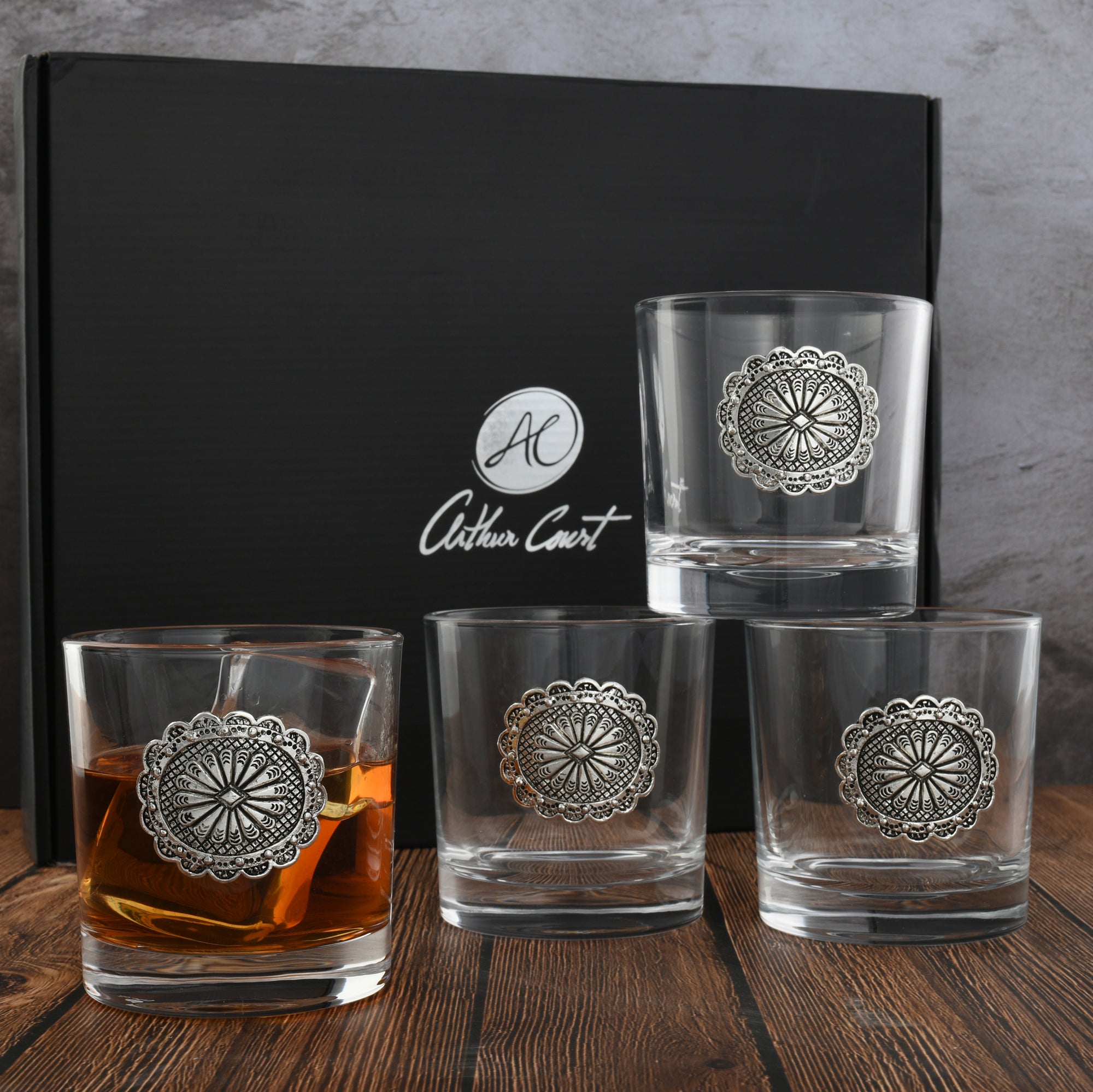 A set of elegant bar glasses viewed from the side, featuring intricate silver detailing, perfect for entertaining essentials.