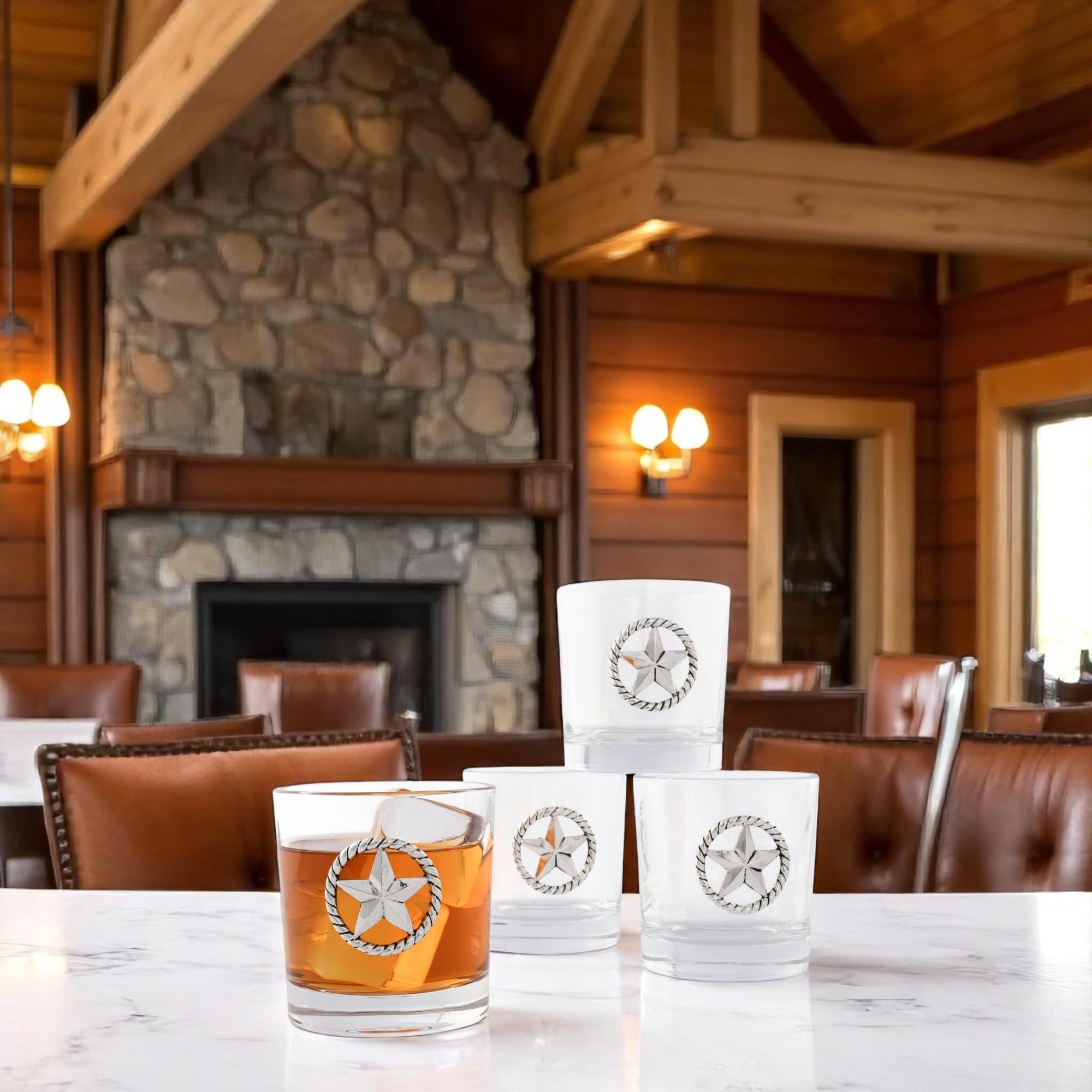 Four bar glasses with star emblems, viewed from a side angle, showcasing modern classic drinkware.