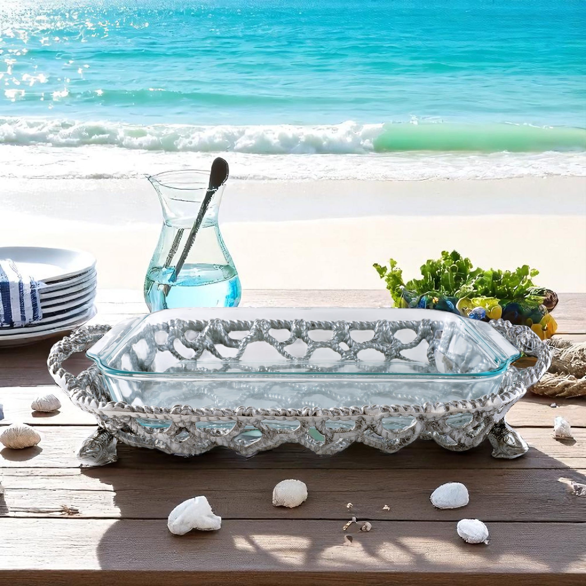 A casserole server with intricate fish and net design displayed from a side angle, ideal for coastal decor and entertaining essentials.