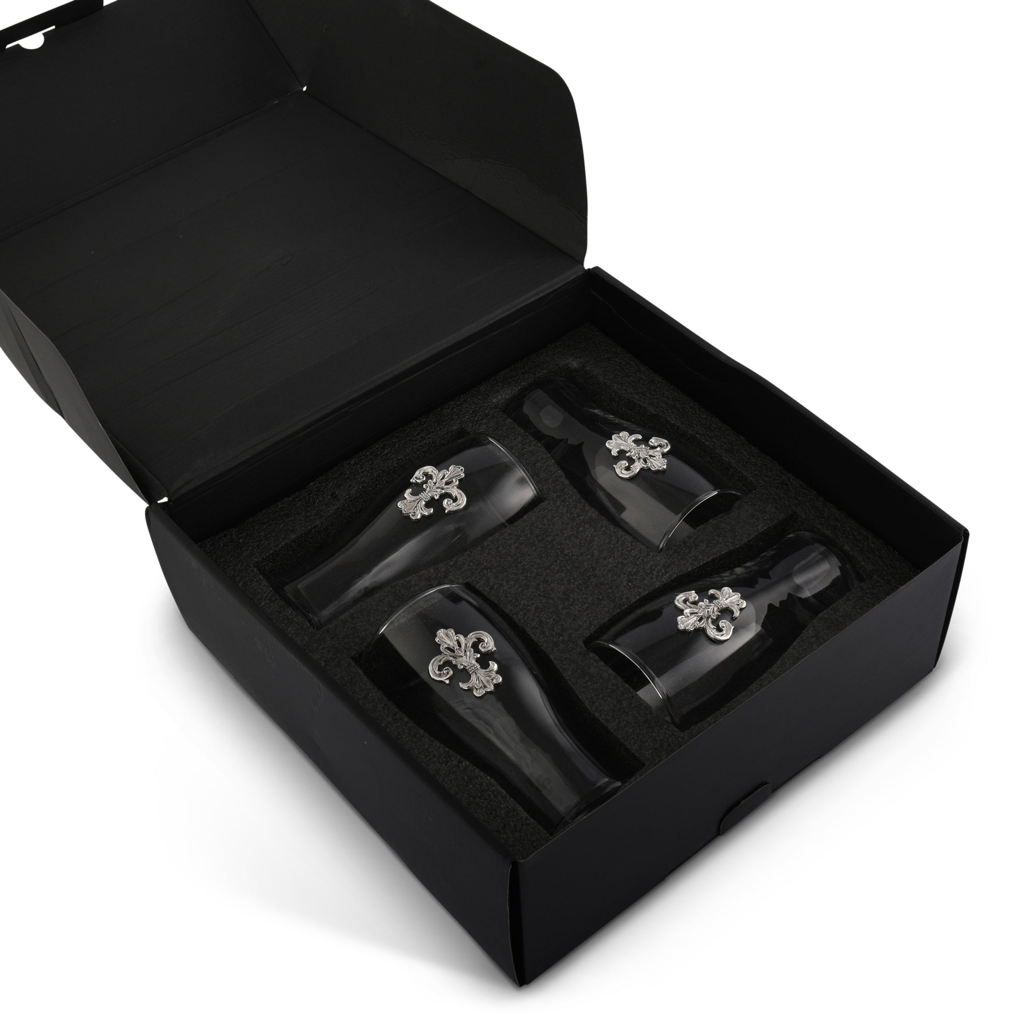 A set of fleur-de-lis beer glasses shown at an angle, featuring one filled with amber beer, perfect for entertaining essentials.