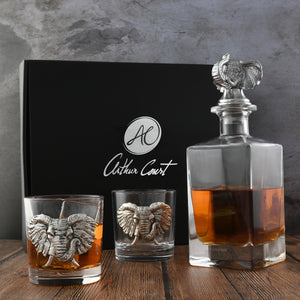 Arthur Court liquor decanter with elephant motif, viewed from the side on a wooden surface, ideal for luxury home accessory.