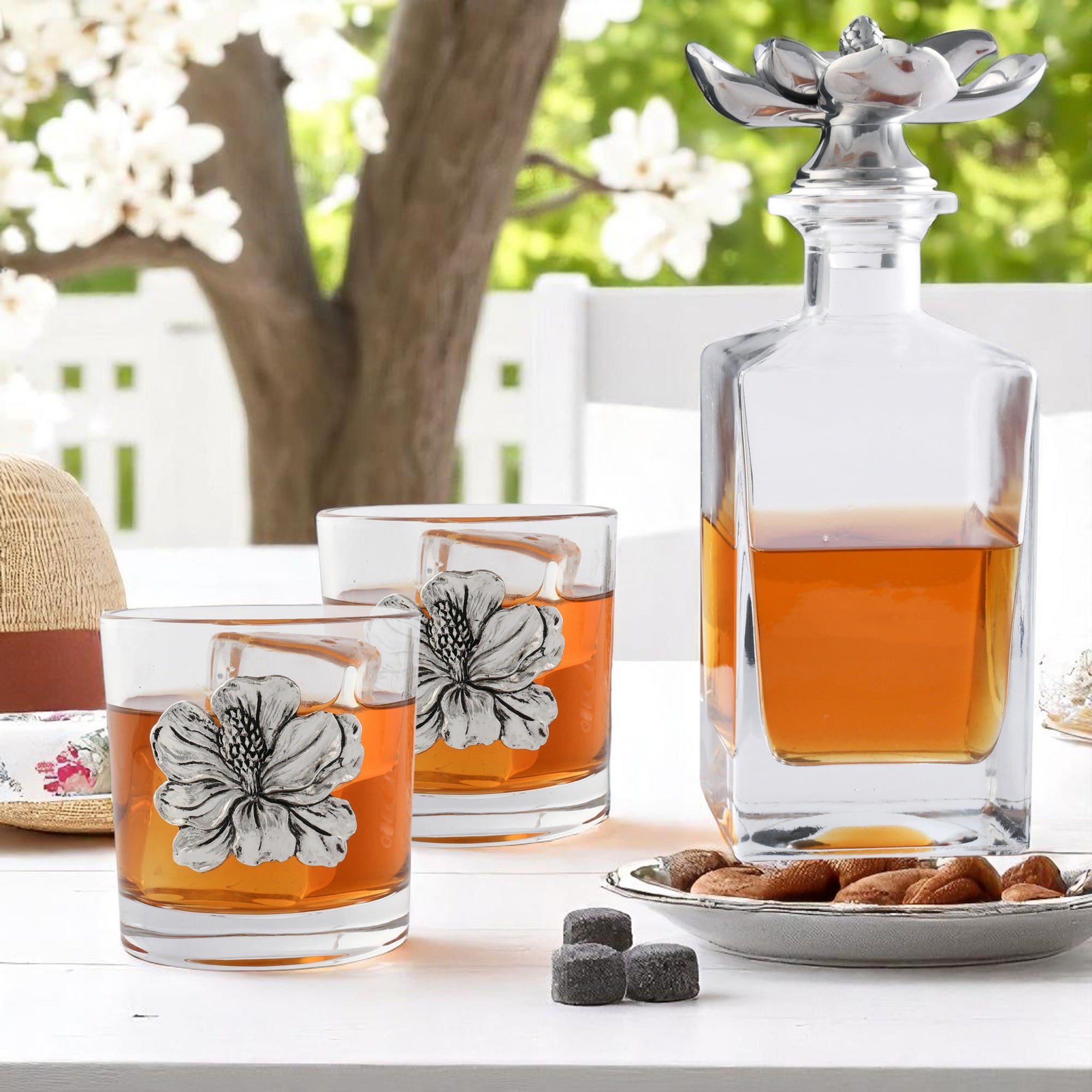 Liquor decanter with floral detailing captures attention in a side view, complemented by matching glasses for a luxury home accessory.