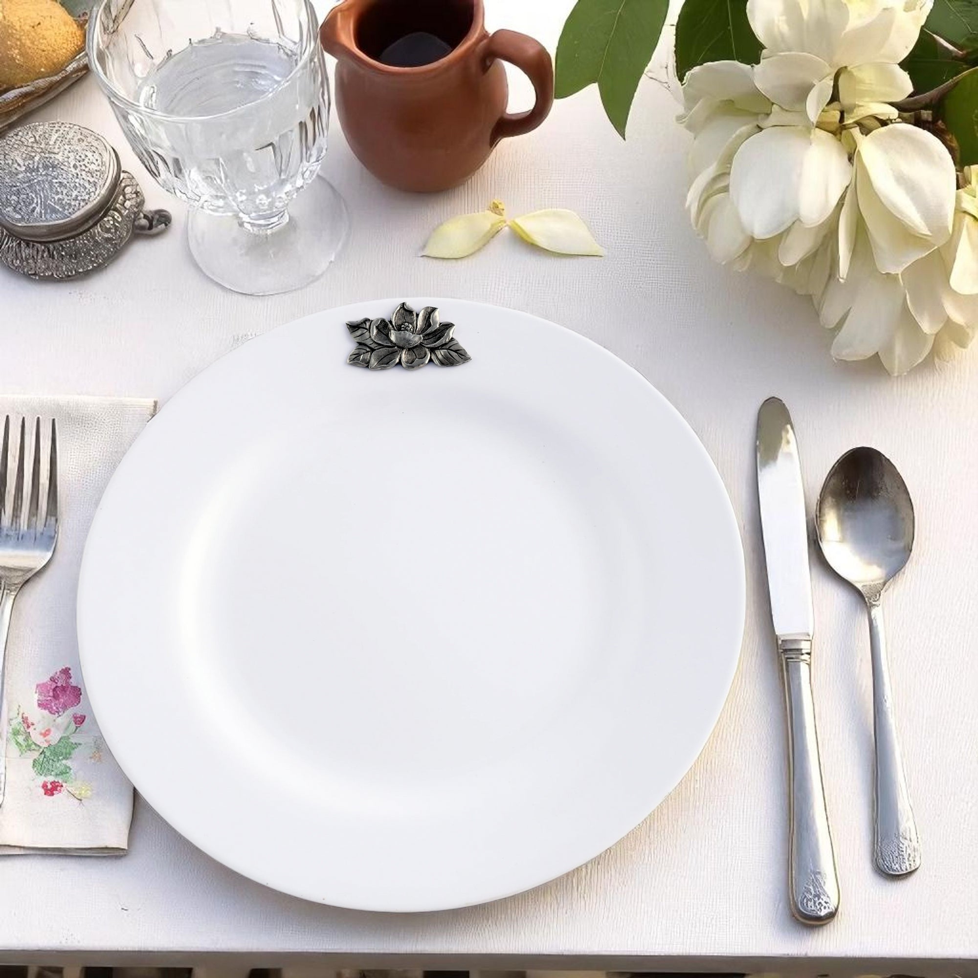 A stack of elegant dinner plates featuring floral accents, angled to highlight their artisanal craftsmanship and modern classic design.
