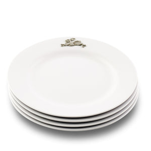 A stack of dinner plates adorned with a rabbit motif, viewed from a side angle, highlighting artisanal craftsmanship.
