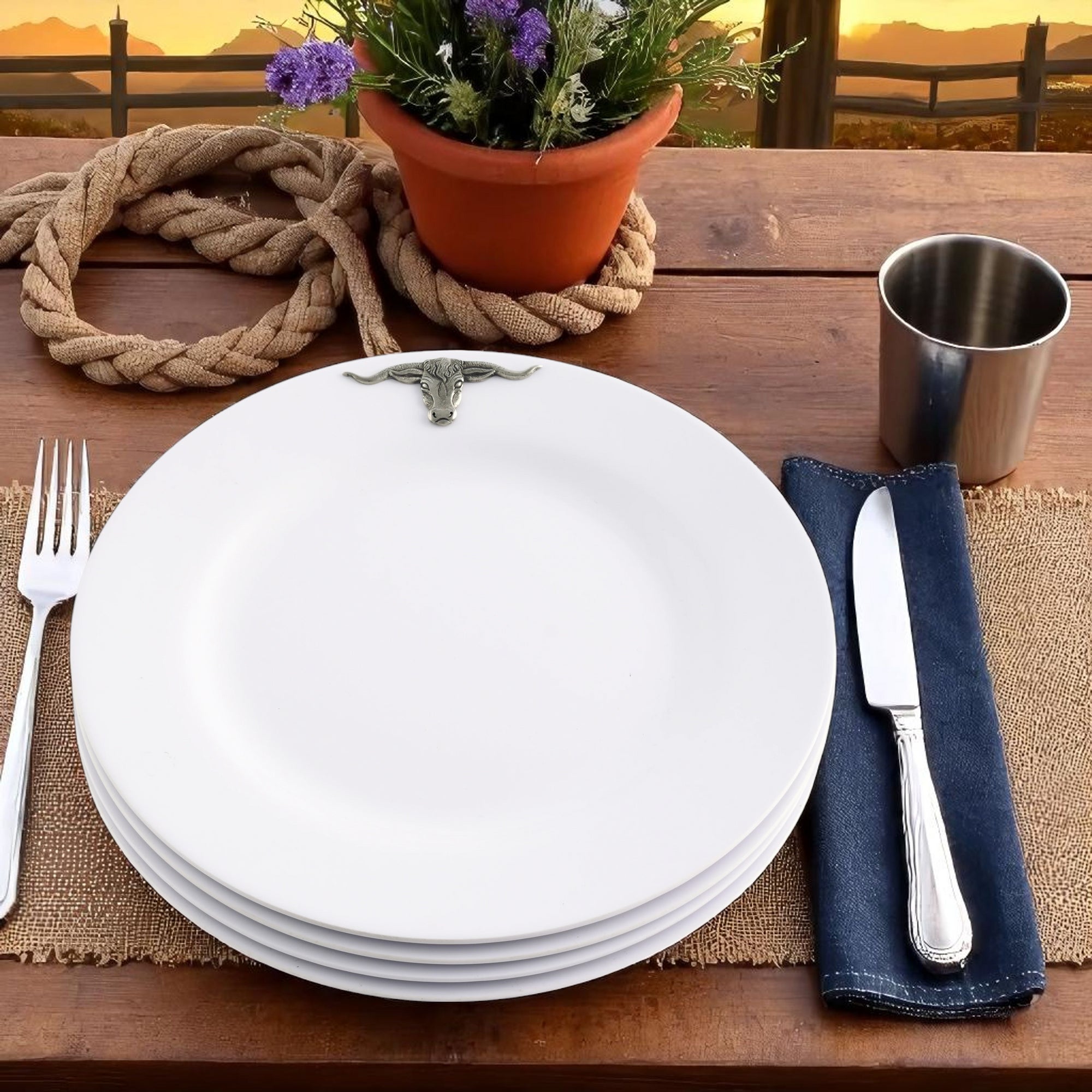 A stack of dinner plates viewed from a slight angle, featuring detailed bull head accents, embodying artisanal craftsmanship.