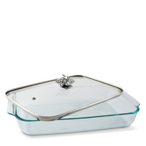Glass casserole server seen from the side, featuring a metallic seashell handle, perfect for coastal decor.