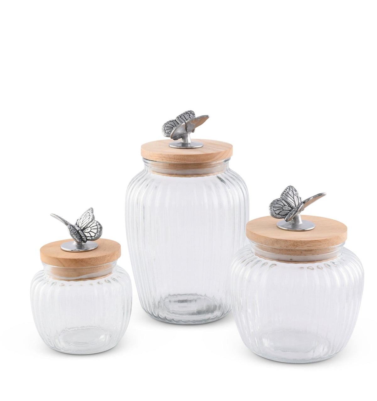 A trio of glass canisters with wooden lids and butterfly embellishments viewed at an angled perspective, ideal for kitchen decor.