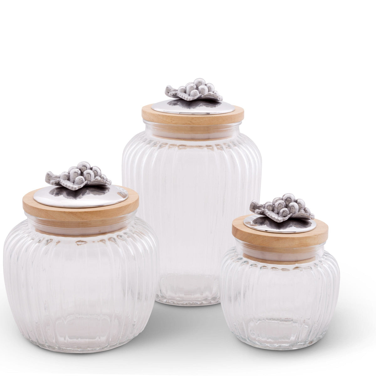 Three glass canisters with decorative lids, viewed at an angle, showcasing elegant accents and premium materials.