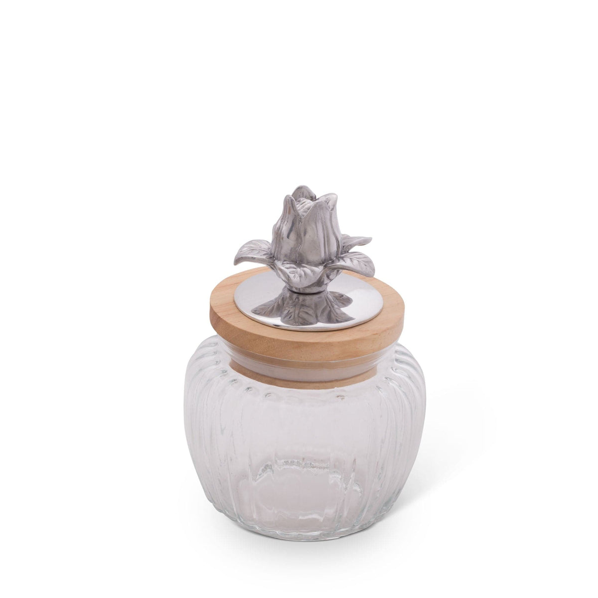 A decorative glass canister viewed from a slight angle, featuring a wooden lid with a silver floral detail.