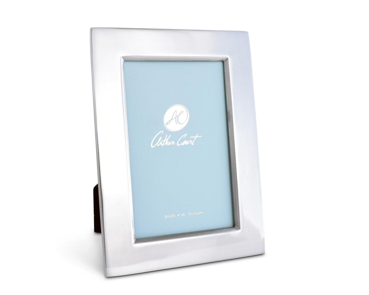 Sleek photo frame angled slightly from the side, showcasing its modern classic silver finish against a simple backdrop.