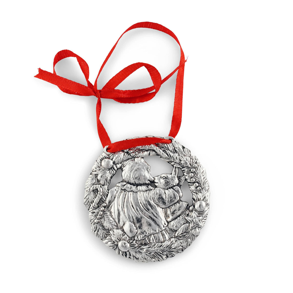 A handcrafted Christmas ornament viewed from above, featuring a detailed silver wreath with a vibrant red ribbon bow.