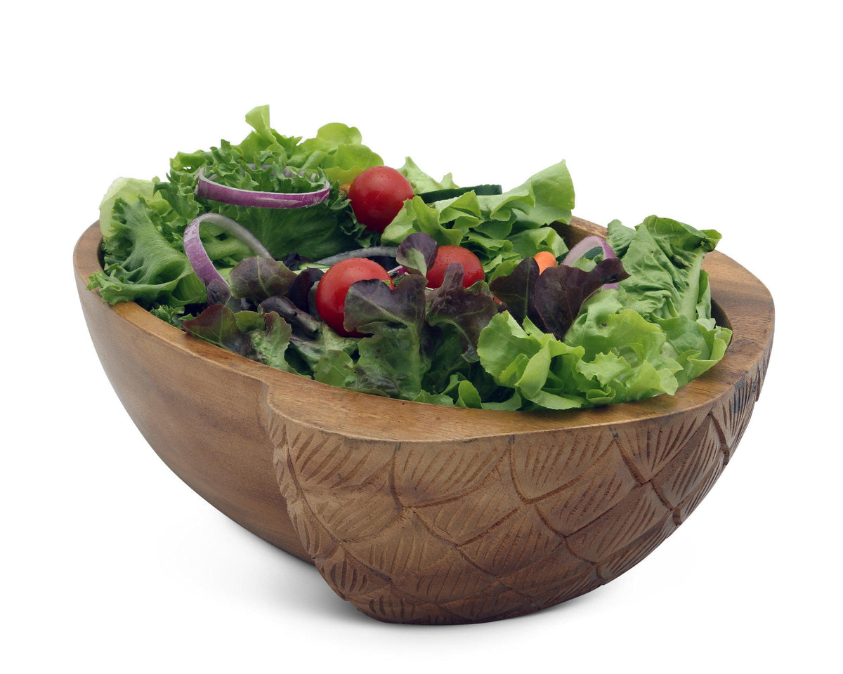 Artisanal wooden salad bowl filled with fresh greens and cherry tomatoes, viewed from the side, showcasing handcrafted detail.