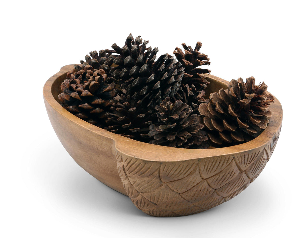 Artisanal salad bowl viewed from the side, featuring carved details and filled with pinecones, ideal for seasonal decor.