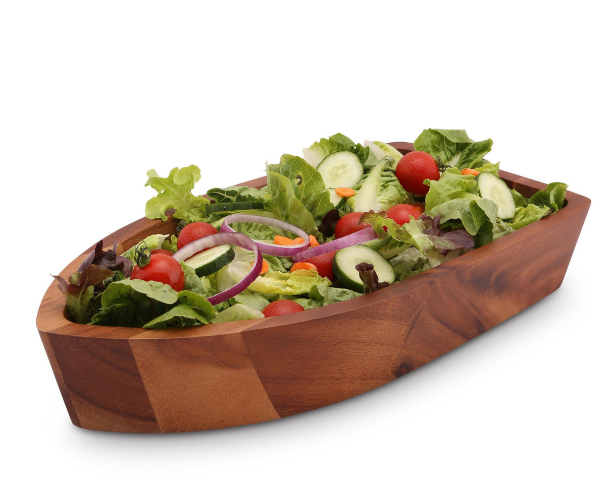 The salad bowl, viewed from a side angle, showcases fresh greens and vibrant vegetables in a wooden decorative bowl.