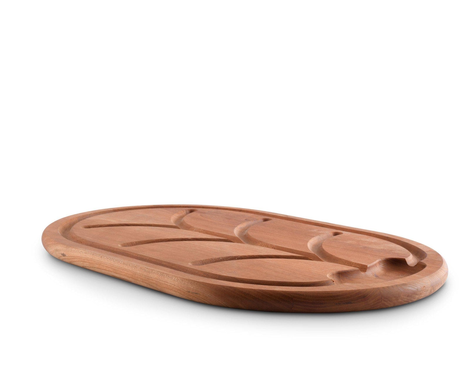 Elegant carving board made from premium wood, angled to show intricate grooves, ideal for kitchen decor and table setting.