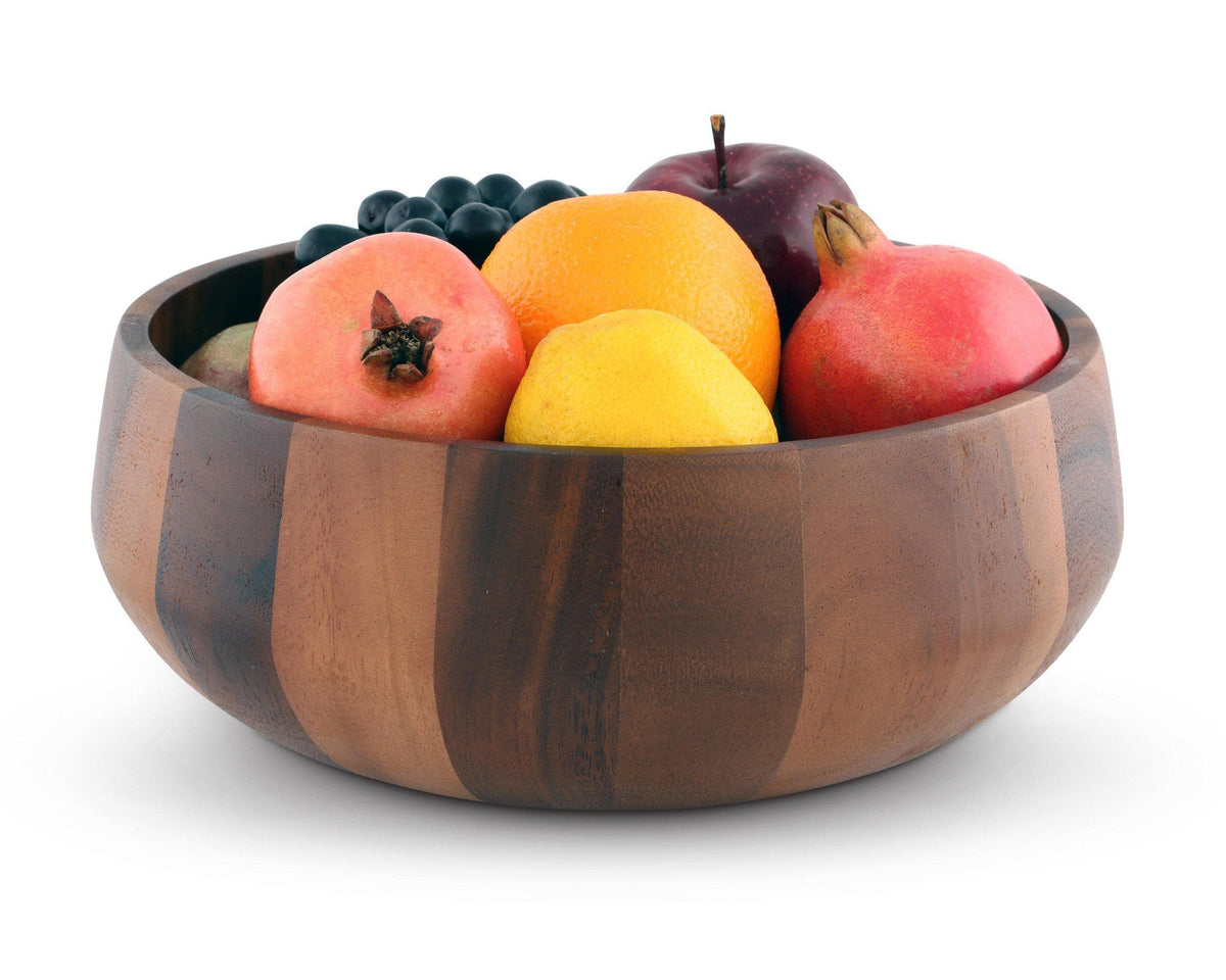 A wooden salad bowl filled with fresh fruit, viewed from a slight side angle, showcasing its artisanal craftsmanship.
