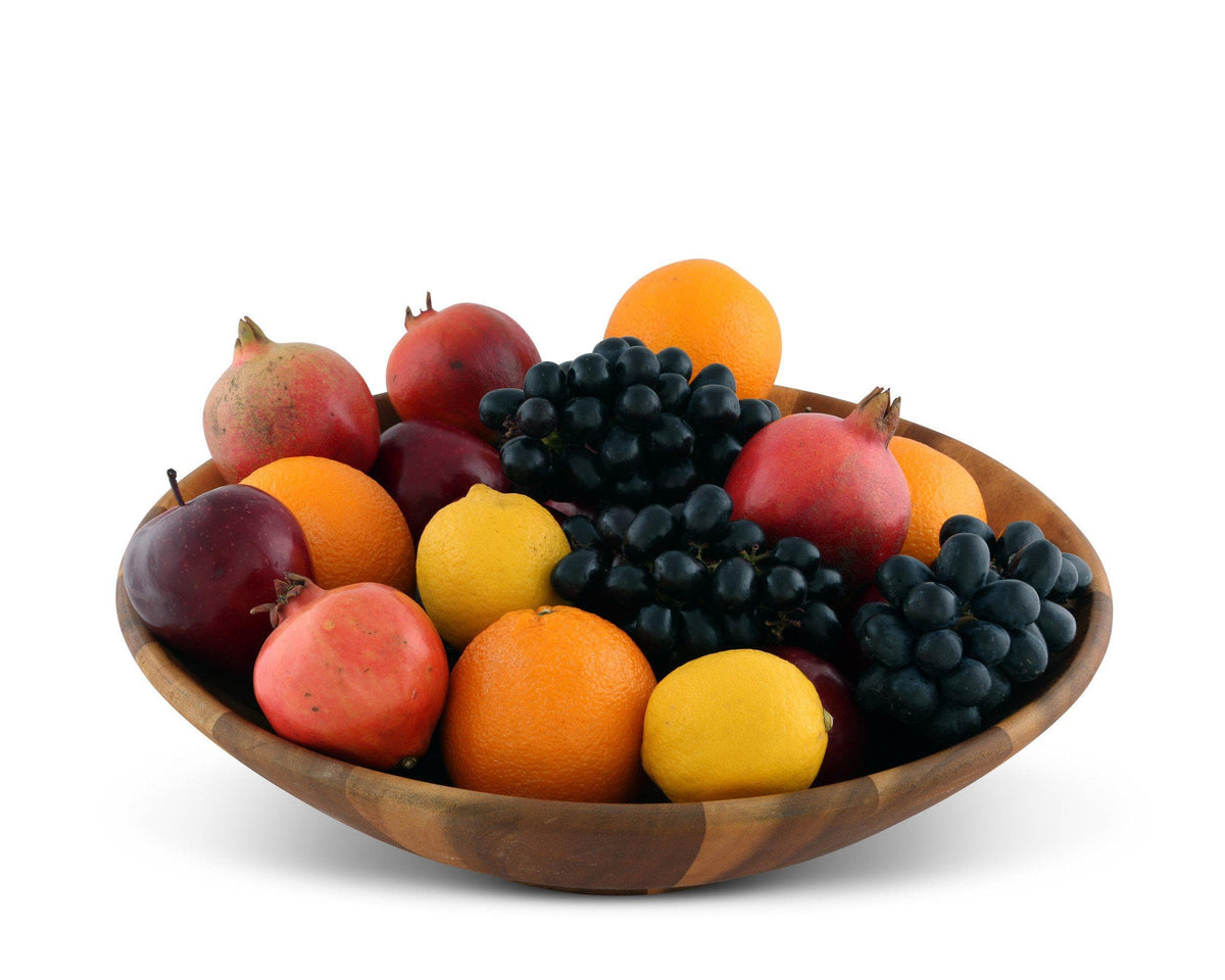 A wooden salad bowl filled with assorted fruits, as seen from a side angle, perfect for kitchen decor.