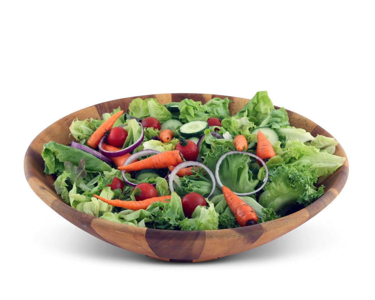 Artisanal wooden salad bowl filled with fresh vegetables, angled for a side view, showcasing elegant kitchen decor.