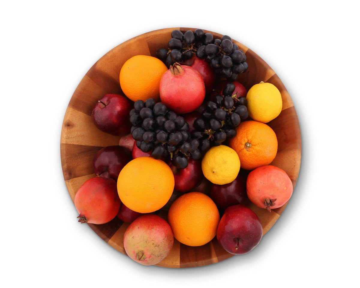 A wooden salad bowl filled with vibrant fruits, including oranges and grapes, as seen from above, perfect for kitchen decor.